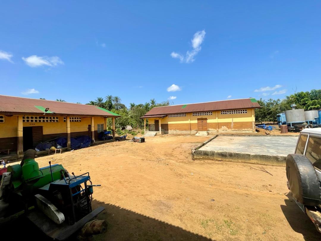 Kondibu agricultural facility with storage buildings and machinery in Sierra Leone